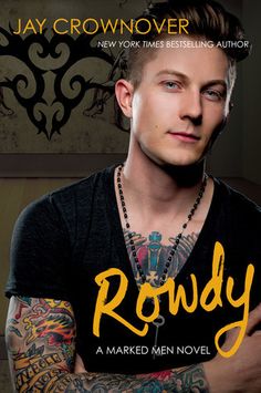 a man with tattoos on his arms and chest standing in front of a poster that says rowdy