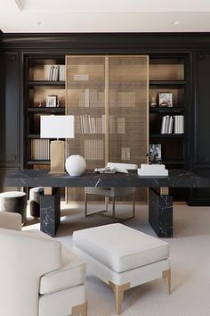 a living room with black walls and white furniture