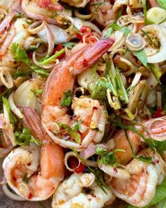 a salad with shrimp, onions and other vegetables