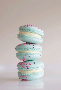 three macaroons stacked on top of each other with sprinkles in them