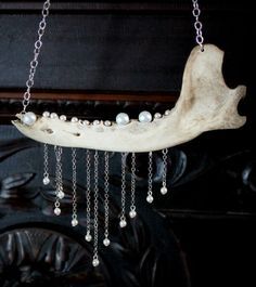 a piece of wood with pearls hanging from it