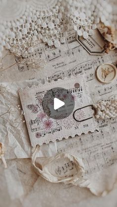 an old piece of paper with music notes and buttons on it, surrounded by crochet doily