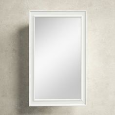 a white framed mirror hanging on the wall