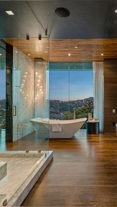 a bathroom with a large tub and glass walls