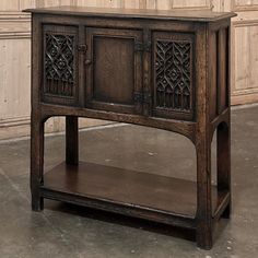 an old wooden cabinet with carvings on the doors