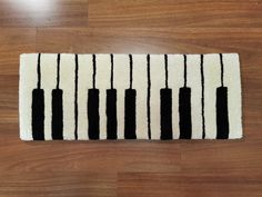 a black and white rug with piano keys on it