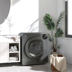 a washer sitting next to a potted plant