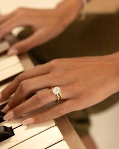 a close up of a person's hand playing the piano