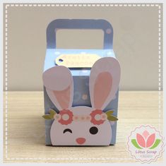 a little box that has some kind of bunny on it's head in the shape of a carton