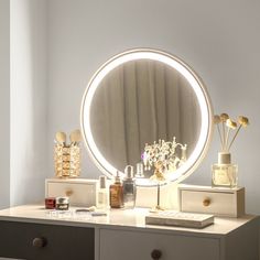 a vanity with a round mirror and various items on it