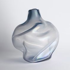 a glass vase sitting on top of a white table