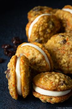 several cookies with white frosting and raisins on a table