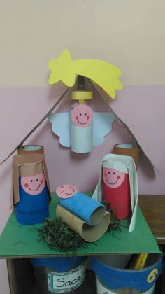 some paper bags sitting on top of a table with other items in them and decorations hanging from the ceiling