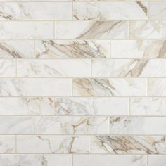 a white and brown marble tile wall