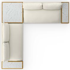 an overhead view of a white couch with pillows on the top and bottom part of it