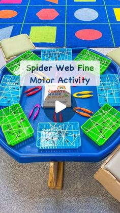 spider web fine motor activity on a blue table with green and yellow squares around it