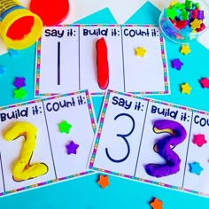 three cards with numbers and shapes to spell out the word build it count it down