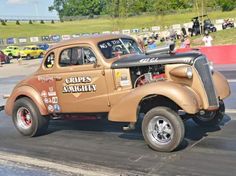 an old model truck driving on a race track