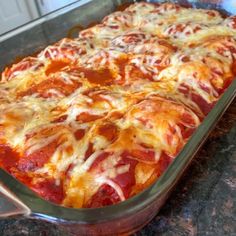 a casserole dish with meat and cheese in it sitting on a counter top