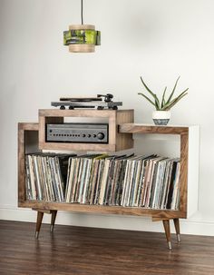 an old record player sitting on top of a wooden shelf