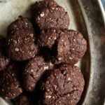 a bowl filled with chocolate cookies on top of a table