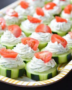 cucumbers with whipped cream and tomatoes on them are ready to be eaten for lunch