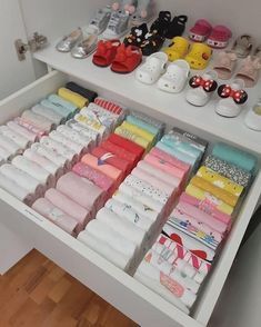 there are many pairs of baby socks on the shelf in the closet, and one pair is for sale