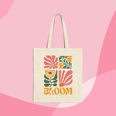 "Unleash your inner flower child with this captivating Bloom Tote Bag! Featuring a vibrant flower design, this delightful accessory adds a touch of blooming beauty to your everyday life. 100% Cotton: built to last, carry all your essentials with ease. Spacious size: 15\" x 16\"- plenty of room for all your stuff. The bag features 20\" handles (made from the same canvas). Tan or Black bag to match your unique style. Keywords: tote bag, flower tote bag, eco-friendly tote bag, sustainable tote bag, Flower Tote Bag Design, Retro Spring Shopping Bag, Eco-friendly Flower Shaped Bags For Spring, Eco-friendly Flower-shaped Bags For Spring, Cool Tote Bag Design, Tote Bag Flower Design, Tot Bag Flowers, Style Keywords, Flower Mothers Day Gift