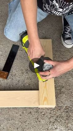 a person using a power tool to cut wood planks with a sanding machine