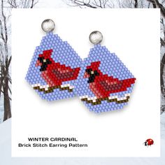 the earrings are made out of legos and have red birds on them, as well as white snow