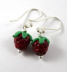 pair of strawberry earrings on white background