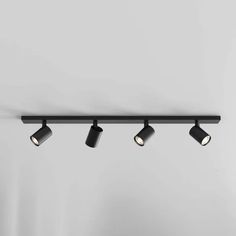 three black track lights hanging from the ceiling