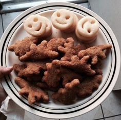 a white plate topped with cookies and smiley faces