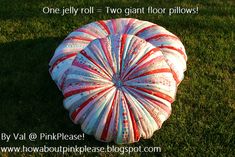 a large round pillow sitting on top of green grass