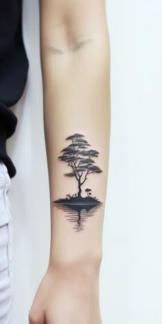 Underarm tattoo showcasing a tree by a peaceful lake, its silhouette mirrored in the water. A design celebrating nature's beauty, growth, and harmony. Bonsai Tattoo, Geometric Tattoo Tree, Tree Tattoo Art, Reflection Tattoo, Tree Sleeve Tattoo, Underarm Tattoo, Artsy Tattoos, Earth Tattoo, Inner Forearm Tattoo