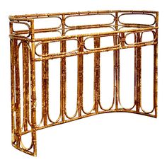 an ornate bamboo console table with glass top and metal bars on the sides, viewed from the front