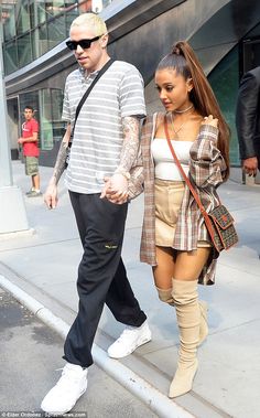 a man and woman walking down the street