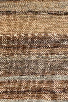 an area rug with different colors and patterns on the carpet, including browns, tans, and browns