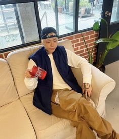 a man sitting on top of a white couch