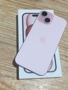 an iphone case sitting on top of a wooden table next to a package with the cover open