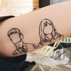 a man and woman's arm with the outline of their faces drawn on it