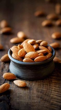 almonds in a bowl on a wooden table