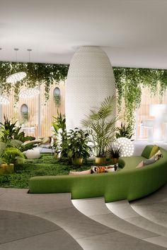 a living room filled with lots of plants and greenery next to a spiral staircase