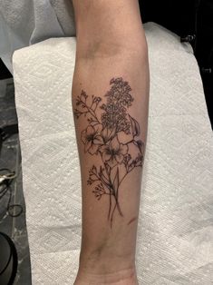 a person with a flower tattoo on their arm