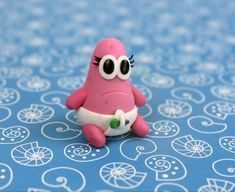 a pink toy sitting on top of a blue table