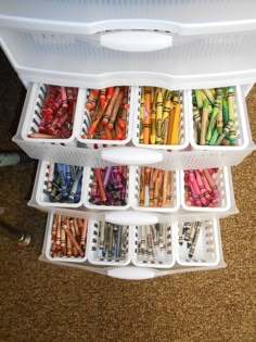 a white container filled with lots of different colored pencils