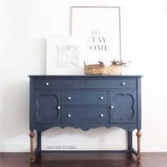 a blue dresser with two baskets on top