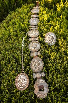 Belt has 5 large conchos & 7 butterfly conchos.  The belt is 36" long. The large conchos are 3 3/4" X 3".  The buckle is 3 7/8" long & 3" wide. The bracelet is one large concho cuff style. The necklace has one large concho on a 31" silver chain.  The concho, also, has a pin clasp on the back, and can be used as a brooch. Concho Belt, Necklace Bracelet, Bracelet Set, Necklaces Bracelets, Jewelry Sets, Silver Chain, Jewelry Watches, Buckle, Cuff