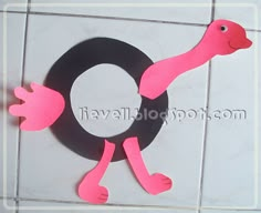 the letter o is made out of paper and has a pink bird on it's back