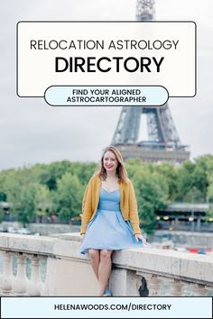 a woman sitting on a wall in front of the eiffel tower